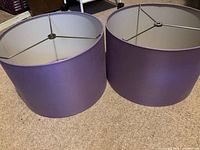 Pair of purple drum shades side by side, exterior and interiors visible