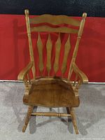 Front view of honey light oak solid wood rocking chair