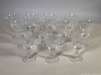Group of eleven clear etched wine glasses front view