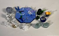 Group shot showing all glass and crystal figurines with mirror base
