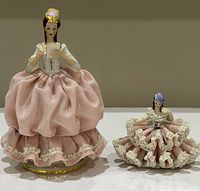 Front view of both figurines showing size difference and lace detail