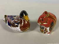 Front three-quarter view of both paperweights