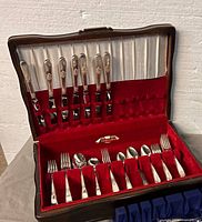 Open chest showing all visible flatware pieces and chest interior