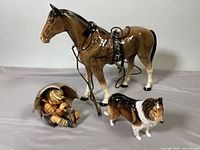 Group shot of three figurines: Melba Ware horse, Goebel Umbrella Boy, Royal Doulton Collie