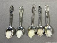 Group shot of all five sterling silver souvenir spoons