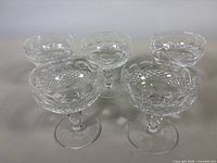 Group of five matching cut crystal champagne coupes