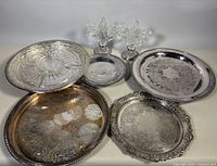 Group image of seven trays and two candleholders