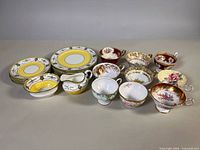 Full lot showing Aynsley plate stacks, matching creamer, bowl and assorted orphan teacups