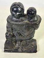 Front view of Inuit mother and child soapstone carving