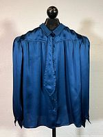 Front view of blue silk Valentino blouse on hanger