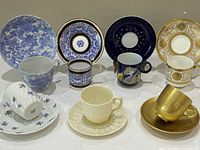 All seven demitasse cup and saucer sets displayed