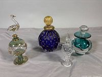 Group shot of all four perfume bottles lined left to right