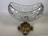 Full view of cut crystal bowl on brass pedestal base