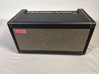Three-quarter front view of amplifier showing grille and casing