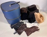 Overall lot showing hat box, five hats and multiple pairs of gloves