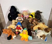 Group shot of all thirteen plush toys on table