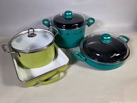 Group of all four cookware pieces showing colors, lids, handles
