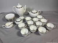 Full set showing coffee pot, teapot, creamer, sugar bowl, cups, saucers, dessert plates