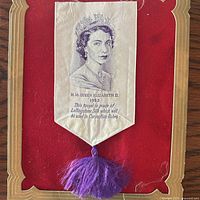 Bookmark on red velvet with portrait and tassel visible