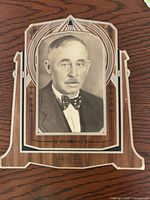Front view of mounted portrait showing subject, Art Deco border and woodgrain finish
