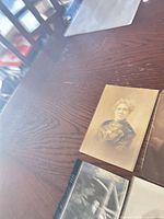 Front view of three cabinet cards on table