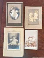 All four cabinet cards arranged on table