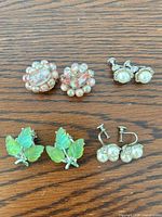 All four earring pairs displayed on wood surface