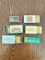 All six matchboxes open showing matches and graphics