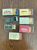 All seven matchbooks/boxes open showing matches