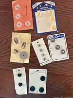 All seven button cards laid out, overview of lot