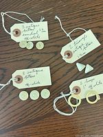 All items grouped with handwritten tags showing quantities and sizes