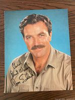 Front of signed color photograph showing inscription and signature