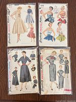 Front view of four Simplicity pattern envelopes showing illustrations and numbers