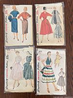 Front view of four pattern envelopes showing illustrations and numbers