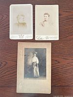 Overview of three cabinet card portraits on wood surface