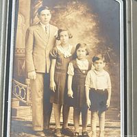 Portrait showing adult male and three children in sepia tones