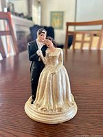 Front view of bride and groom figurine on round base