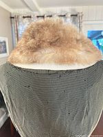 Back view of tan/beige fur collar on mannequin showing overall color and texture