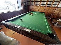 Pool table overall view with balls on green felt