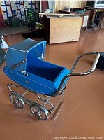 Full view of blue Gendron baby pram with chrome frame, spoked wheels and canopy