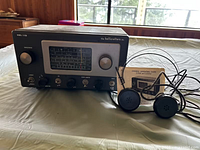 Front view of Hallicrafters S-53A radio with headphones and manual