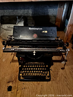 Front view of Remington Standard typewriter with cover behind