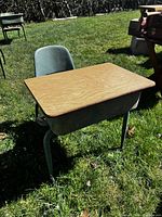 Three-quarter view of desk and chair showing entire set in outdoor light