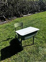 Full view of vintage school desk with attached chair outdoors