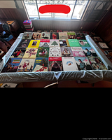 Tabletop view showing approximately 30 vinyl LPs laid out in rows with visible holiday and vocal titles