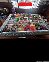 Tabletop view of entire spread of approximately 30 assorted vintage LP records