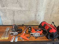 Full lot on table showing both jigsaws, hand tools, blades, planer knives and tool bag