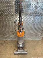 Full view of Dyson DC66 upright vacuum with cord and floor head