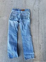 Full back view of Levi's 631 jeans showing denim color, pockets, and overall condition