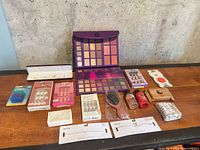 Complete lot laid out on table showing all makeup, nails, hairbrush, lotions and accessories